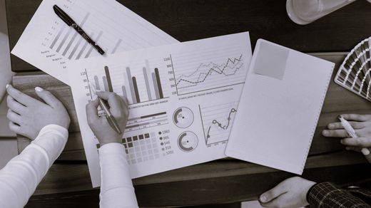 Desk view with some paper that contain firgures and insights of a business