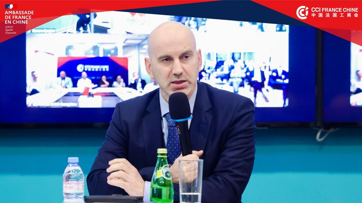 Close-up of Christian Gianella speaking into a microphone at a CCI France Chine seminar.
